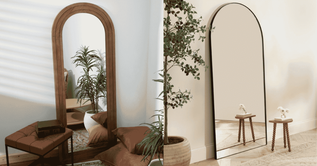 Black arch mirror positioned above a console table in a bright UK hallway