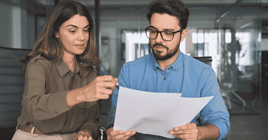 Divorce attorney helping a client review financial assets, debts, and settlement documents.