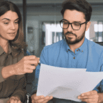 Divorce attorney helping a client review financial assets, debts, and settlement documents.