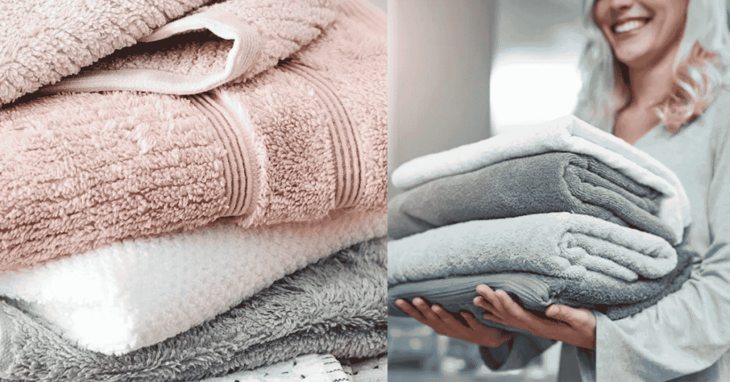 Stack of fluffy white bath towels neatly folded on a wooden bathroom shelf
