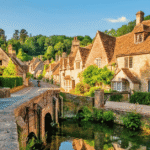 Scenic view of honey-coloured stone cottages along the River Coln in Bibury Cotswolds