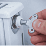 Using a flat-head screwdriver to bleed a radiator valve