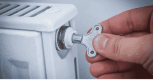 Using a flat-head screwdriver to bleed a radiator valve